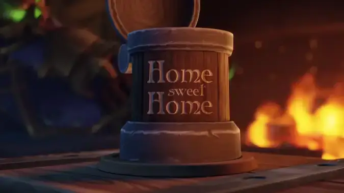 Set on a table is a wooden mug carved with the words, Home Sweet Home.