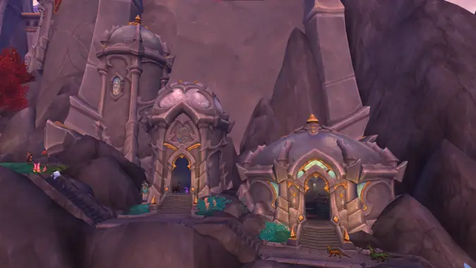 A screenshot of three house-sized buildings in Valdrakken in the Dragon Isles.
