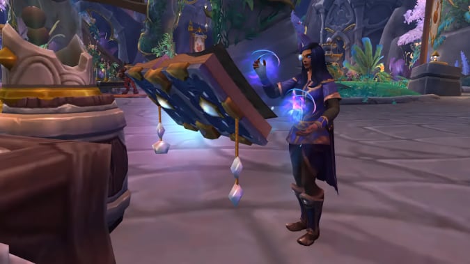 A woman with dark blue hair and a monocle casts a spell from a floating book.