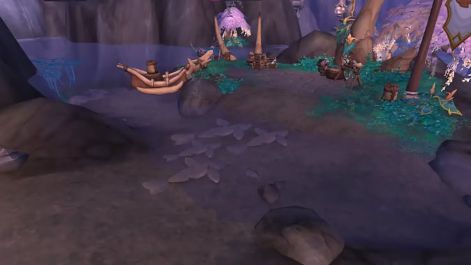 A path across a creek is lined with shark-shaped stepping stones.