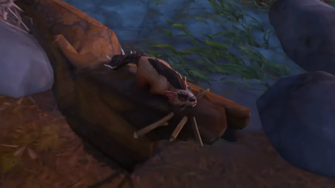 A spiky beaver holds sticks in its mouth.